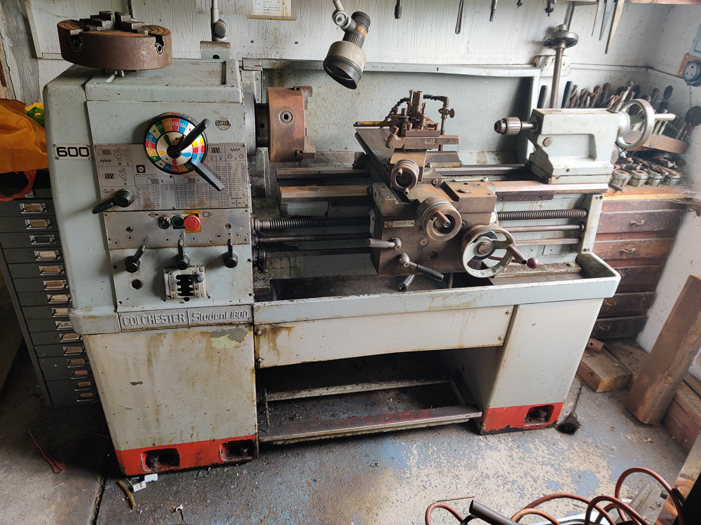 Large metal lathe in a workshop.