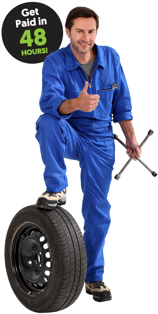 Mechanic holding a tool and gesturing a thumbs up.