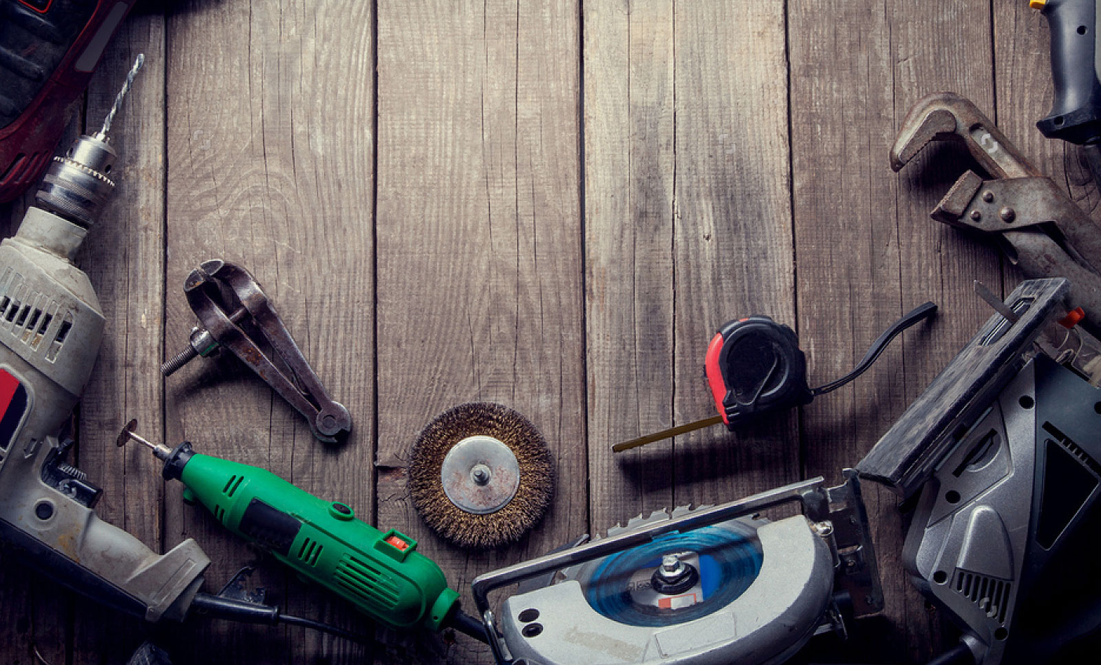 Hand and power tools on a wooden slatted floor.